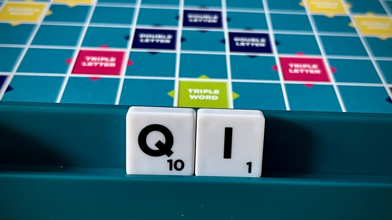 QI on a Scrabble tile rack